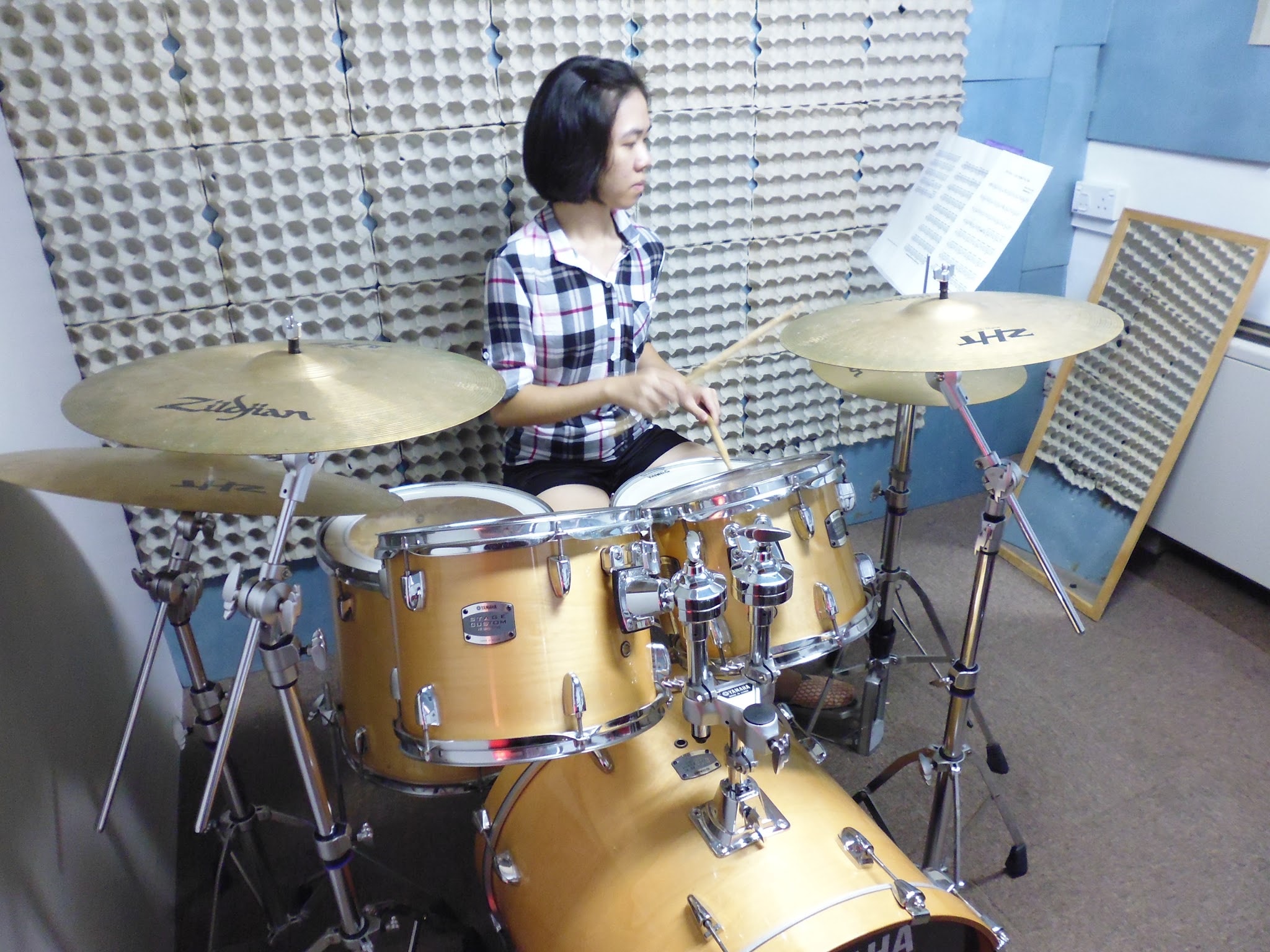 Drummer performing under concert lights