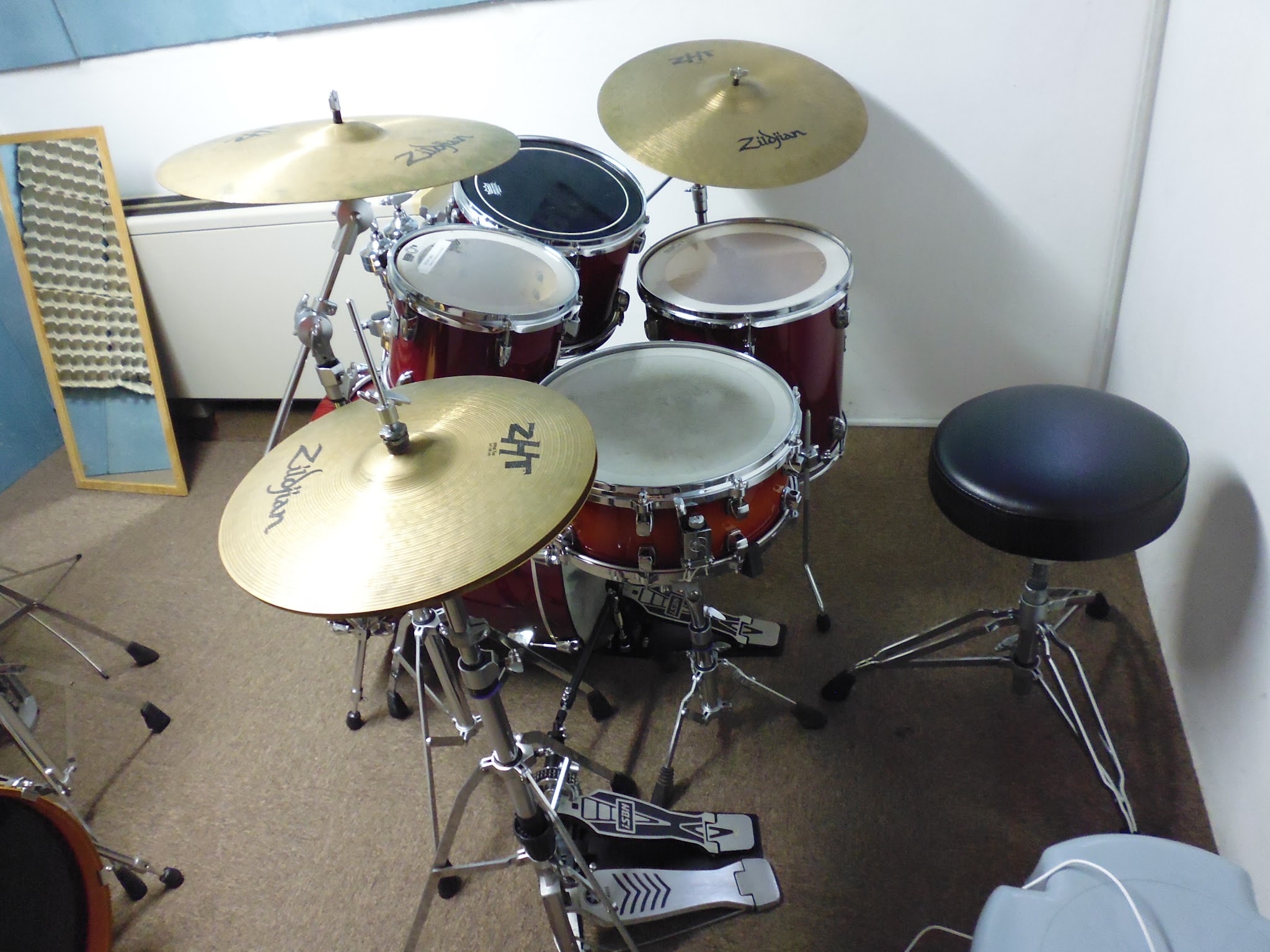 Red drum kit with cymbals in the teaching studio