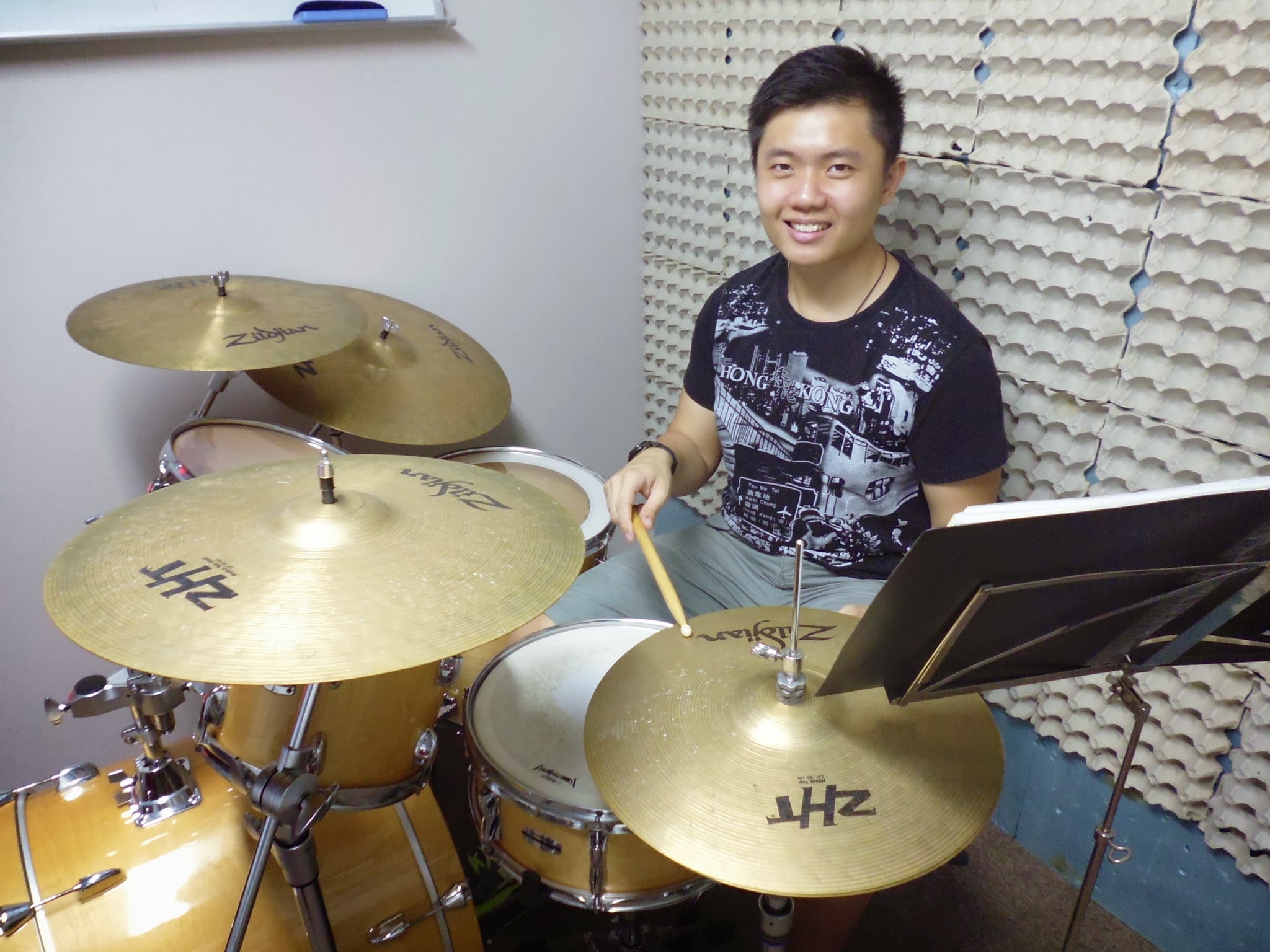 Smiling student drummer in the practice studio